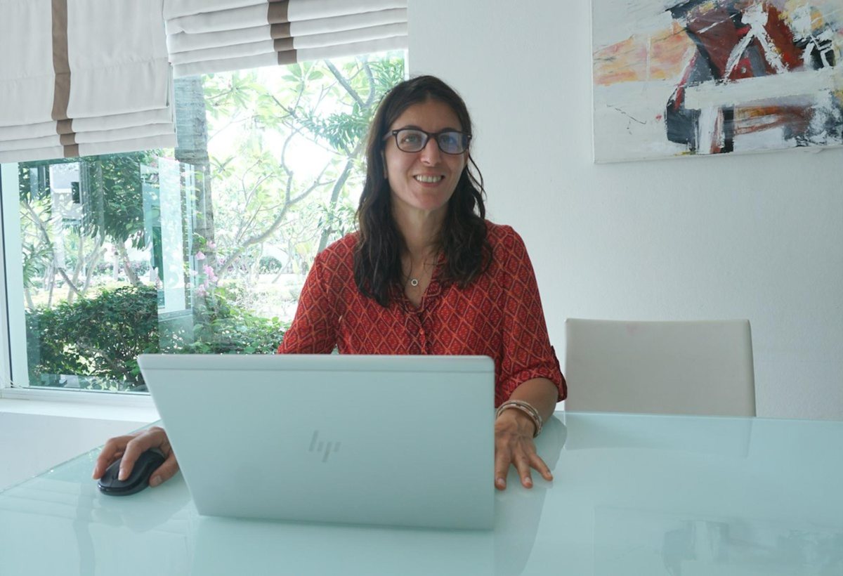 A learner at her laptop in a live class